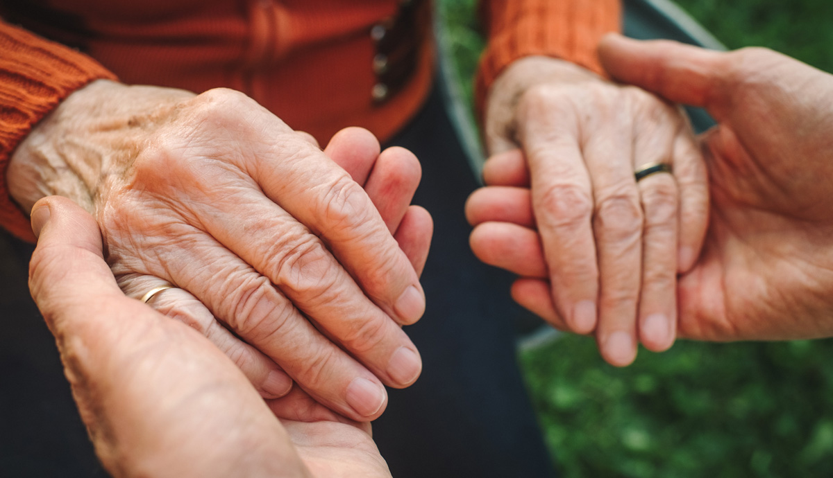 Up close shot of two people holding hands
