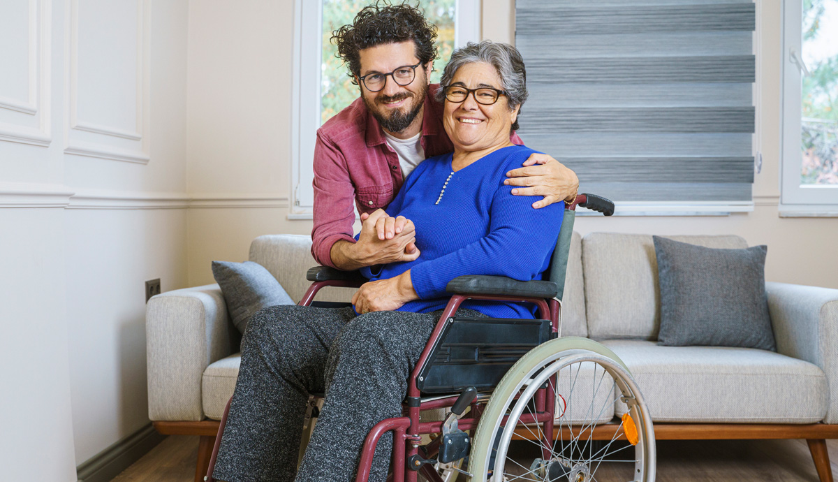 Mother in wheelchair receiving hug from son